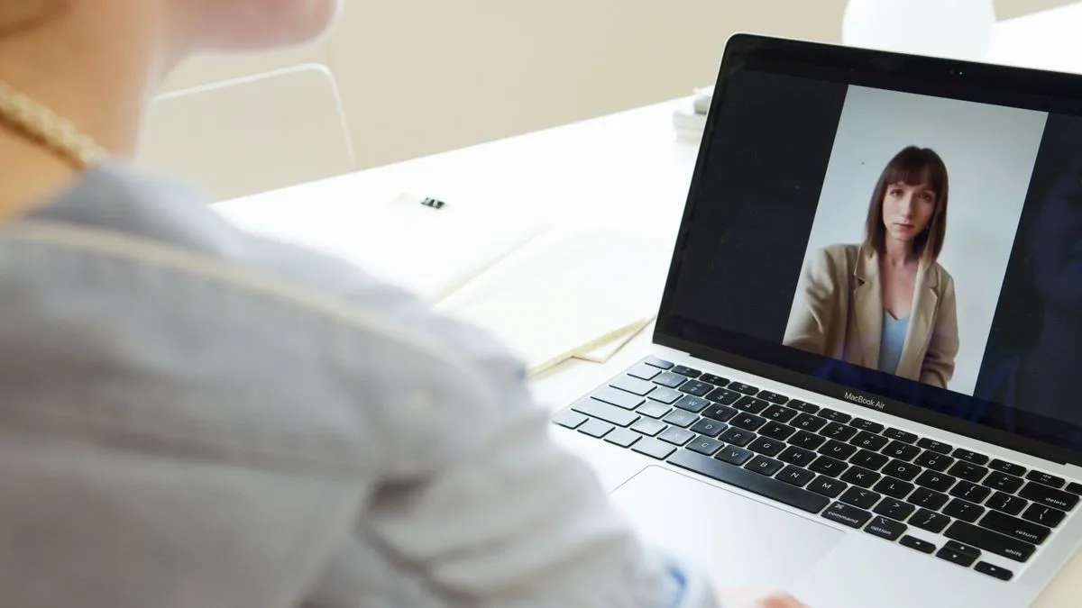 Person having an online therapy session with a clinical psychologist by video call
