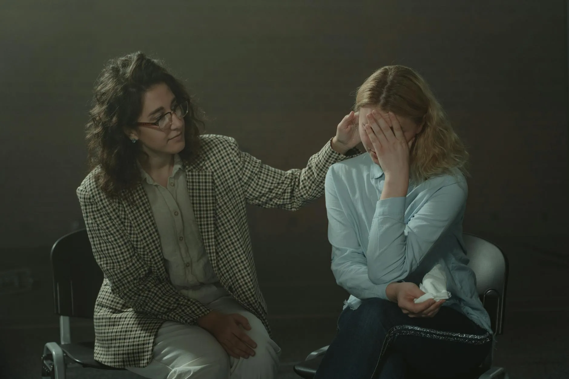 Person having peaceful video therapy session on laptop in comfortable bedroom setting