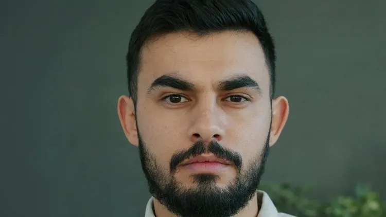 Person looking in a mirror, reflecting on their sense of self and personal identity